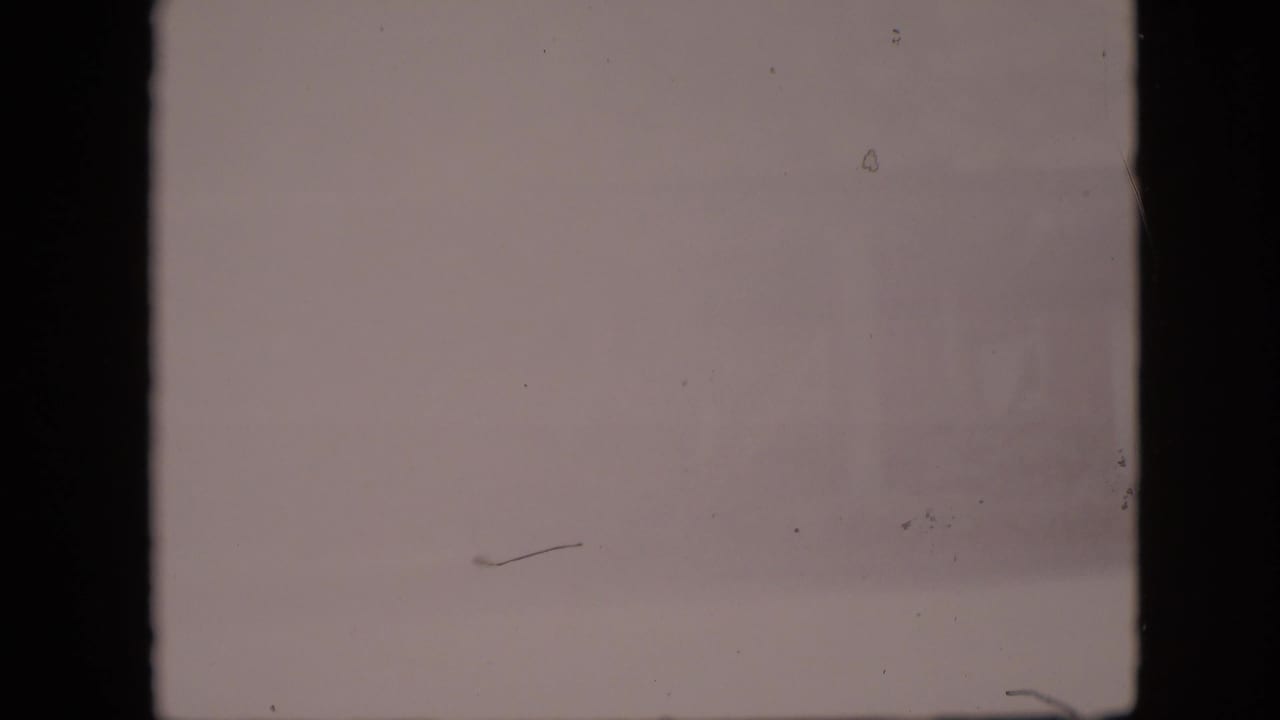 Overexposed pale frame with only faint building detail visible at the right edge.