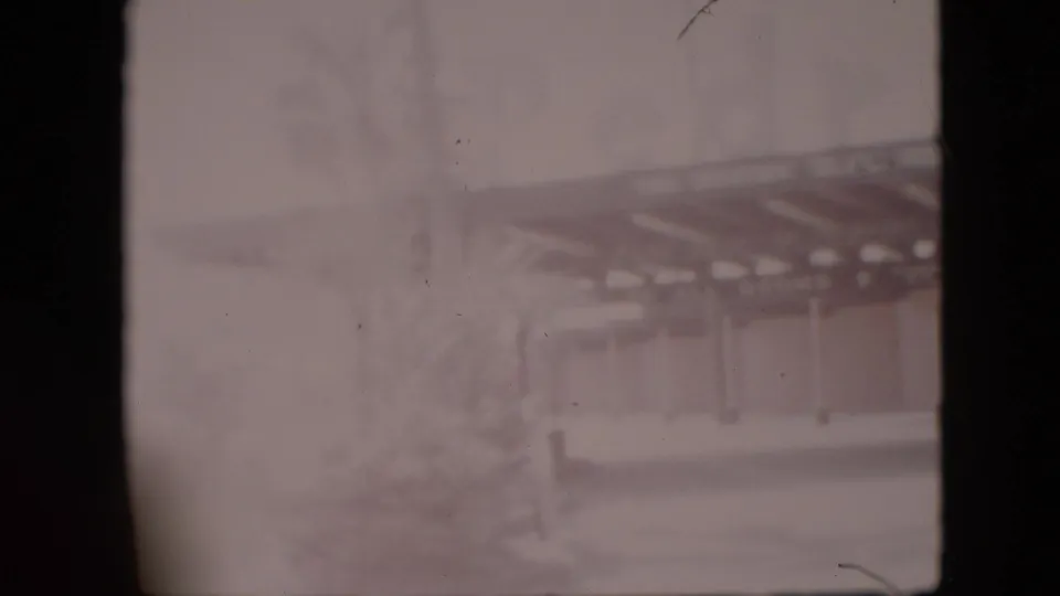 Faded 1958 Pennsylvania 8mm frame showing what appears to be a roadside restaurant or similar establishment with a covered entrance, seen through soft focus and heavy film wear.