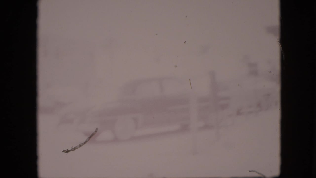 Very faded frame with a classic car near a roadside building and dark 8mm frame borders.