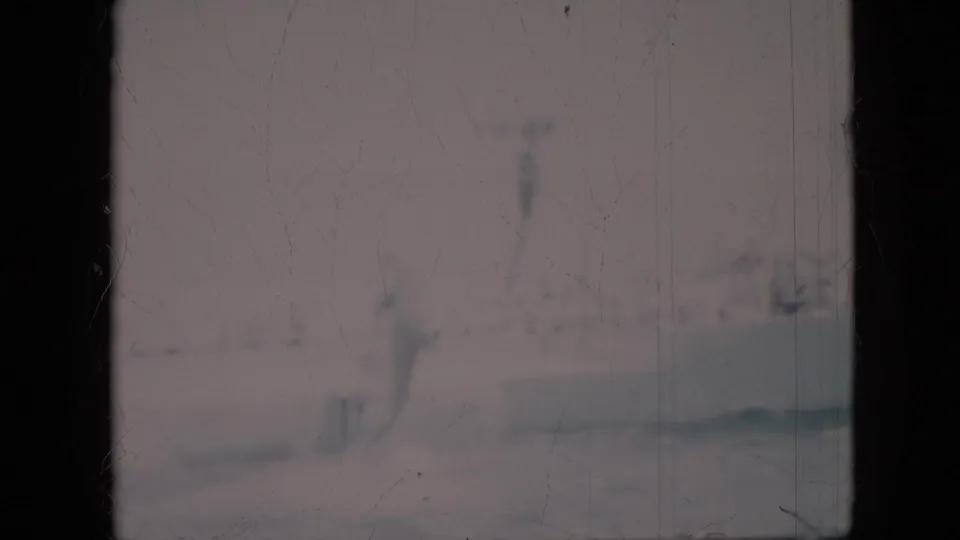 1958 Pennsylvania 8mm frame showing murky green water with faint fish-like forms, pale bottom reflections, and visible film scratches.