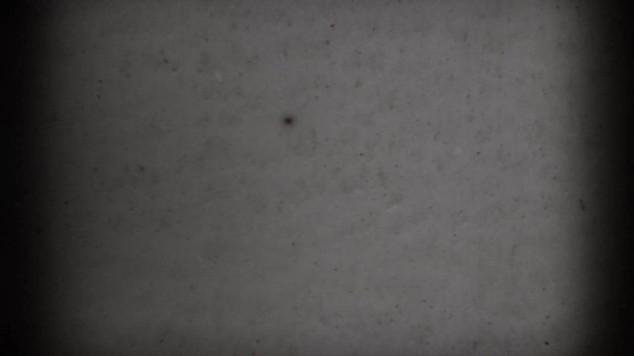 1966 Athens, Ohio 8mm frame showing a soft gray blank television-like screen surface with darkened edges, vertical banding, and visible film dust.