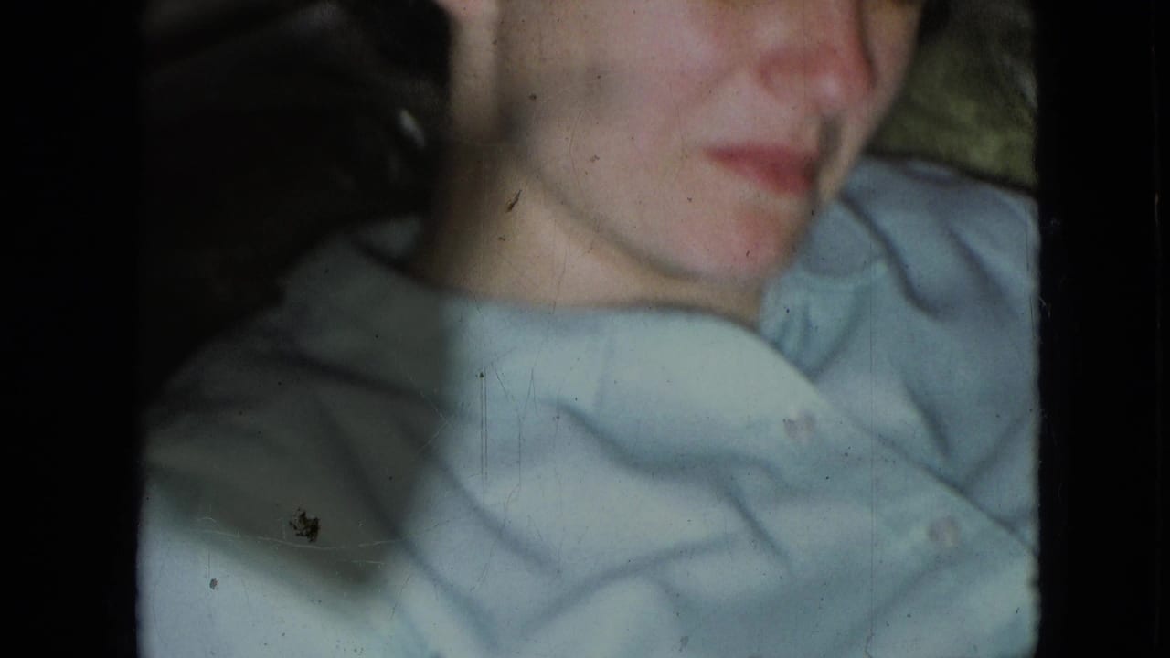 Soft 1966 8mm close-up from Athens, Ohio showing a young boy in a light blue collared shirt with film edges and slight fading visible.