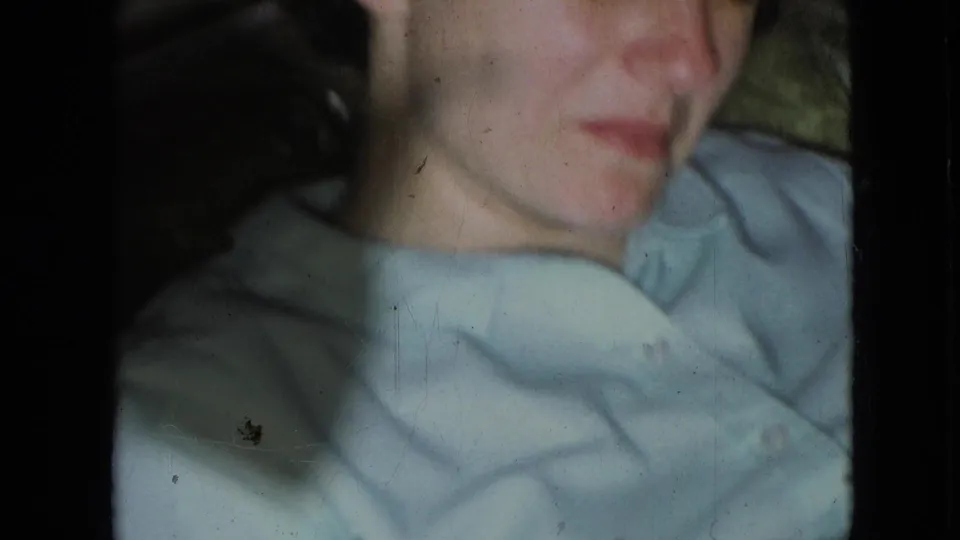 Soft 1966 8mm close-up from Athens, Ohio showing a young boy in a light blue collared shirt with film edges and slight fading visible.