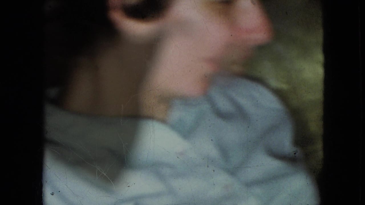 Young boy in profile, slightly blurred, wearing a light blue shirt.