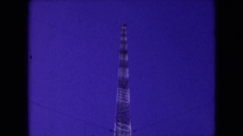 Athens, Ohio 1966 frame with a partial view of the communication tower near the lower edge, surrounded by blue-purple sky and visible 8mm scan artifacts.