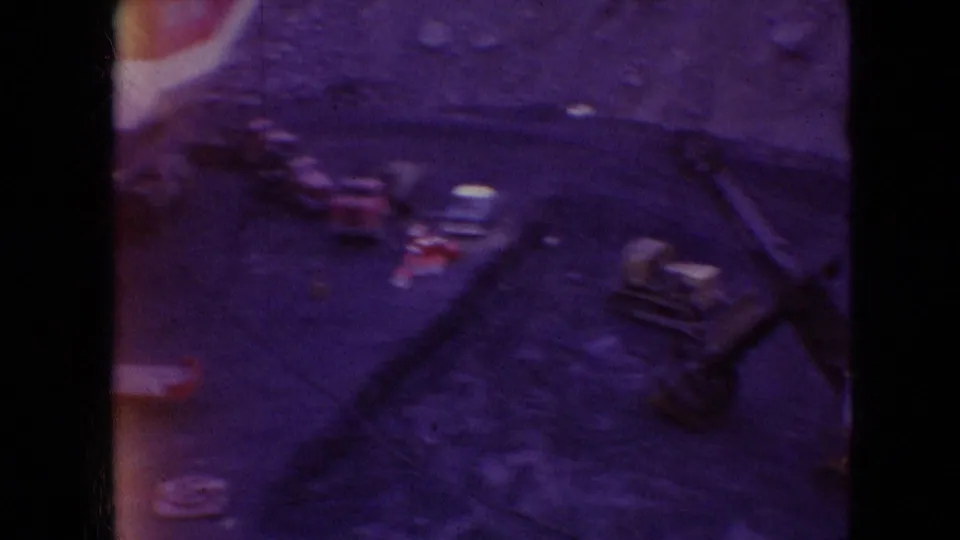Color-faded 8mm frame from the Athens, Ohio Silver Spade clip, showing indistinct machinery details, dark borders, and a purple-yellow exposure cast.