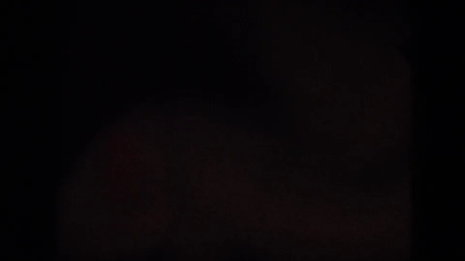 The clip ends on a nearly black frame with faint 8mm film texture and minimal visible detail.
