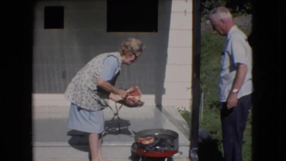 The 1966 backyard footage shows an older woman holding food or a plate near the small red grill while an older man stands at the edge of the frame.