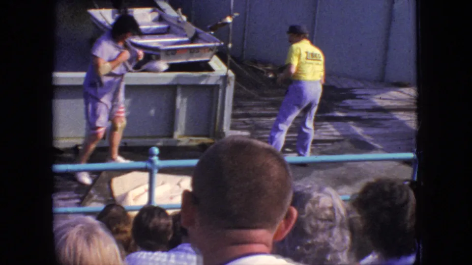 A dockside moment from the 1966 New Jersey pier show shows two performers or staff near a small boat, with the audience visible in the foreground.