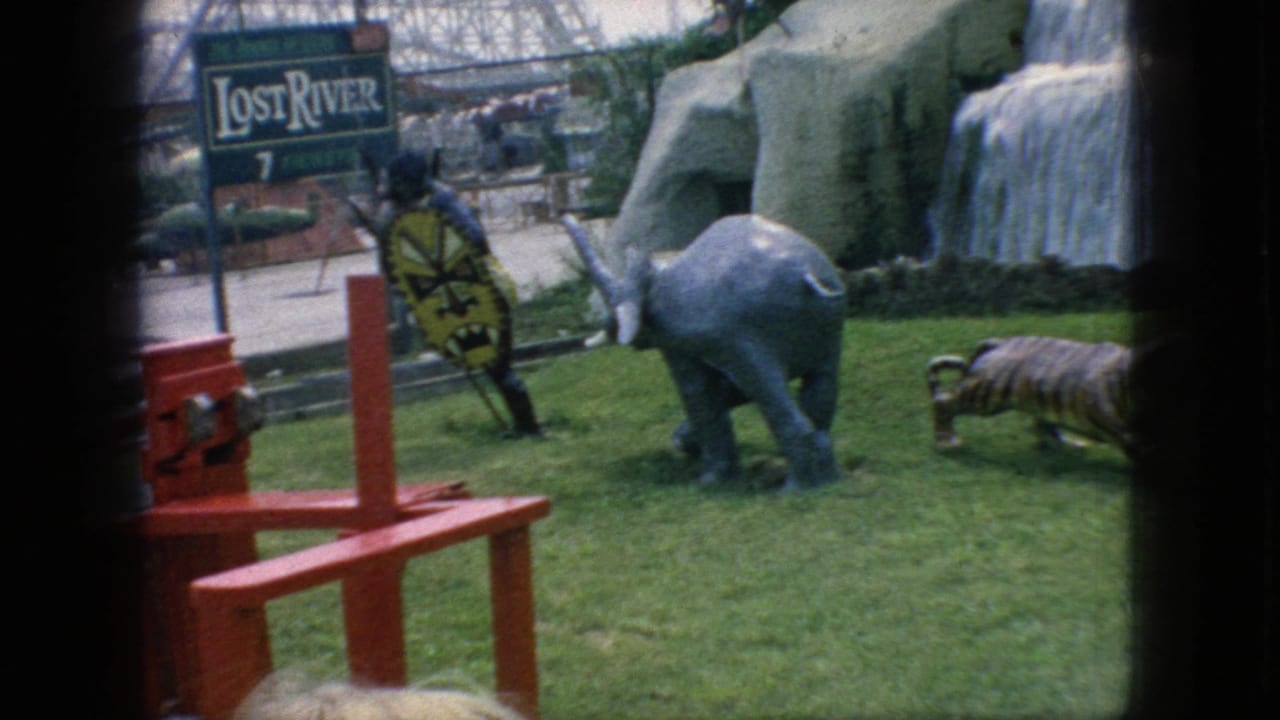 A Lost River sign, elephant statue, tiger figure, and red ride structure are visible at the attraction.