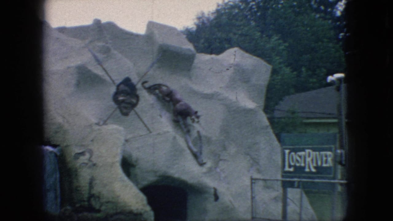 1966 New Jersey 8mm frame showing the Lost River amusement ride facade with a simulated rock cave entrance, mounted props, and partial signage.