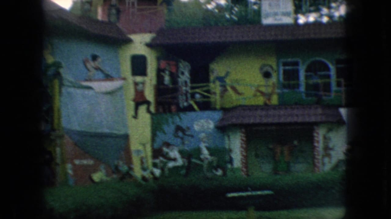1966 New Jersey 8mm frame showing a brightly painted two-story building with cartoon-like murals, arched windows, lawn, and a small fountain or basin in front.