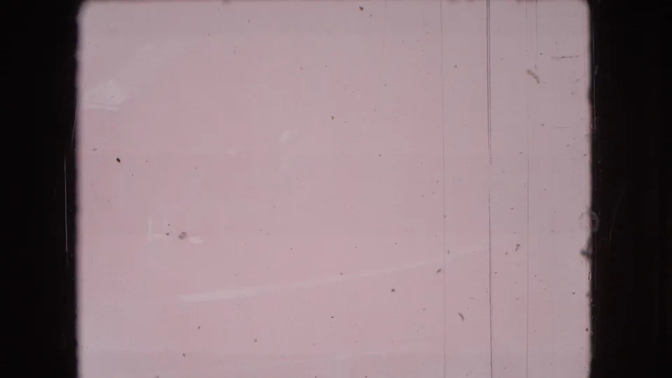 Mostly blank scratched 8mm frame following the performance image, showing pale exposure, dust, vertical marks, and faint remnants of the pool edge.
