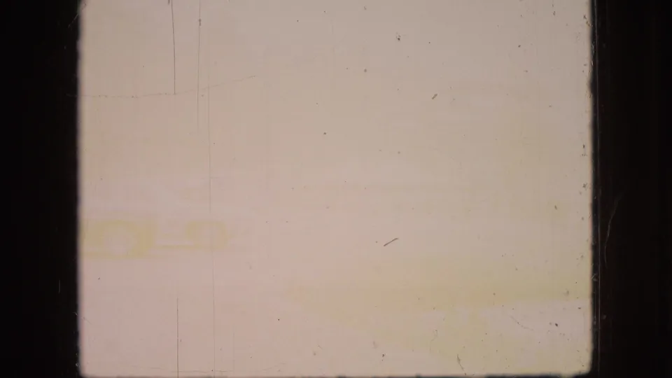 A washed-out 1966 Ohio 8mm frame shows faint outdoor shapes near the lower edge, with yellow fading and visible film scratches dominating the view.