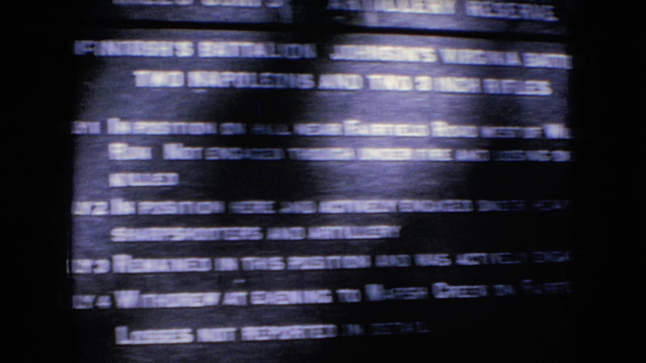 Soft, handheld 8mm frame showing a dark Civil War interpretive plaque with mostly blurred white text and horizontal streaking.