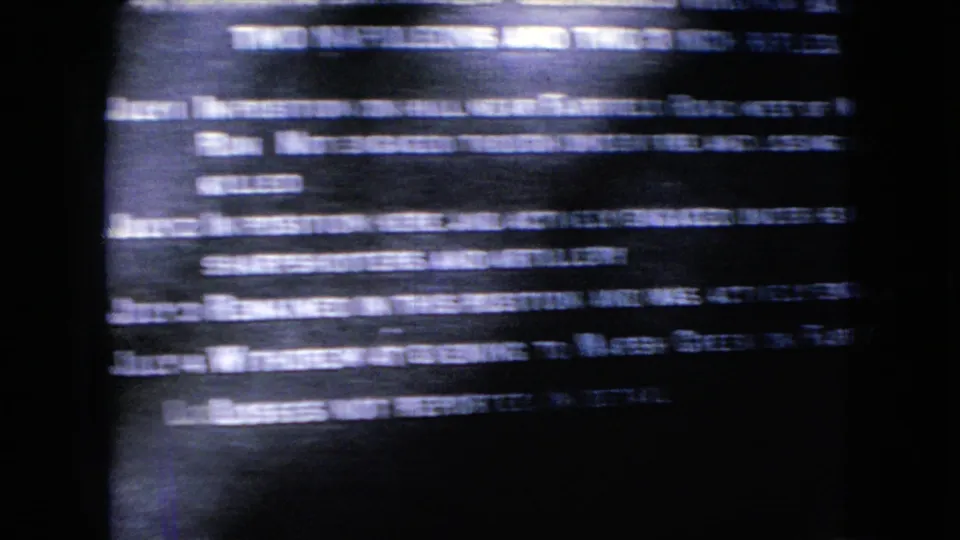 Blue-tinted 8mm close-up of a Civil War marker with white lines of text, partially obscured by motion blur and exposure variation.