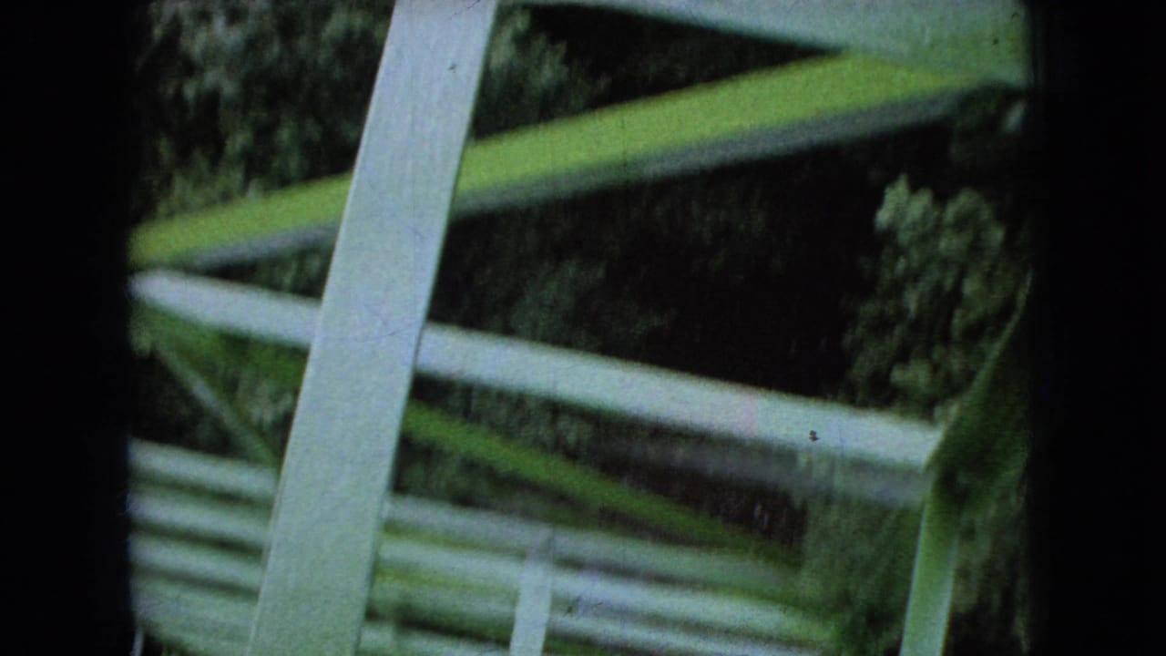 Green metal rails and structural supports seen from close range.