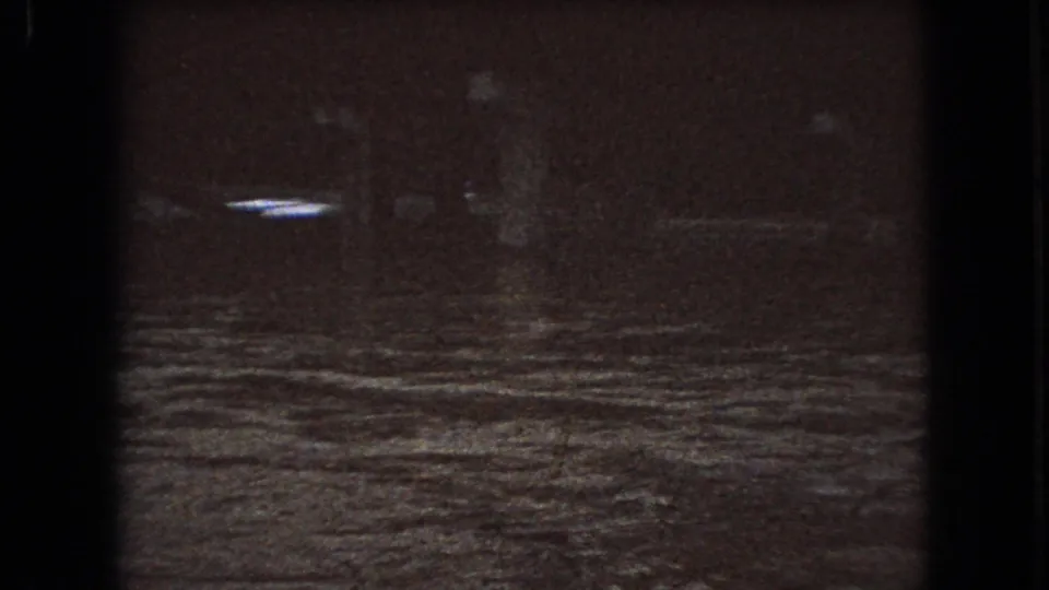 The final 1966 Ohio frame shows a dark river surface with a brighter reflected streak, visible grain, and dense low-light shadow.