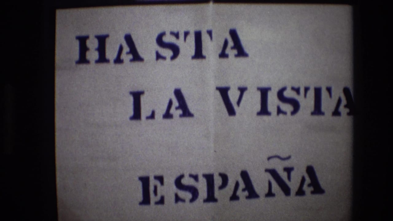 Portugal 1972 8mm frame of the “HASTA LA VISTA ESPAÑA” sign, with the phrase cropped at the right edge and dark vertical film borders visible.