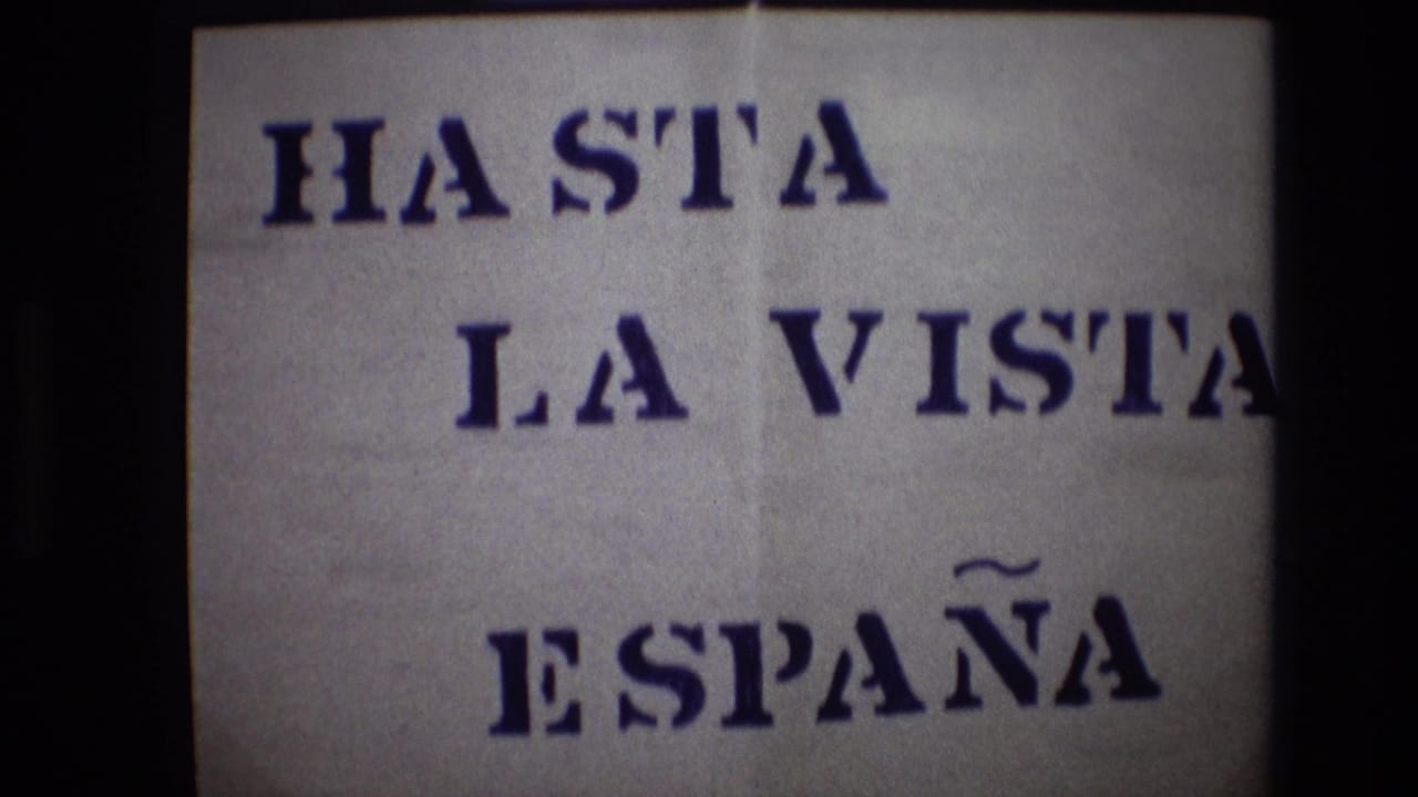 Close-up of the sign with “HASTA LA VISTA” and “ESPAÑA” visible across the paper.