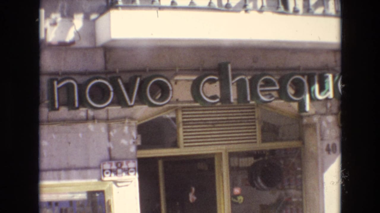 Storefront facade with a large novo cheque sign and doorway.