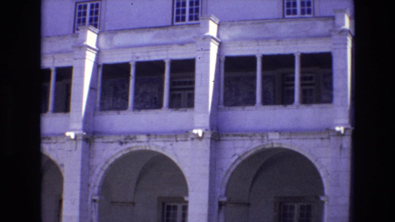 1972 Portugal street-view frame with arched openings, column details, and upper windows on a pale urban building.