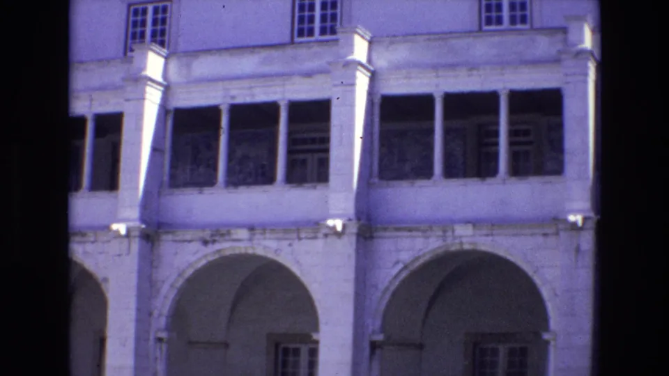 1972 Portugal street-view frame with arched openings, column details, and upper windows on a pale urban building.