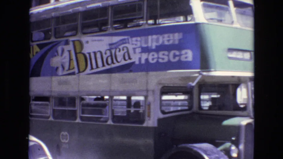 A close roadside view shows the double-decker bus passing, with the Nova Binaca super fresca advertisement filling much of the frame and lower deck windows below.