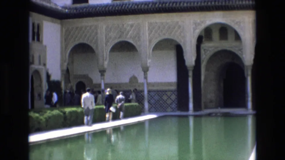 The final frame shows adult tourists near clipped hedges and a reflective pool, with Moorish-style arches and a dark doorway behind them.