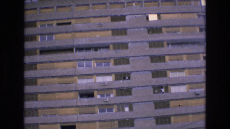 Final 1972 Spain frame of Hotel Luz Granada exterior, showing repeated concrete balcony lines, window bays, shutters, and contact-sheet scan borders.