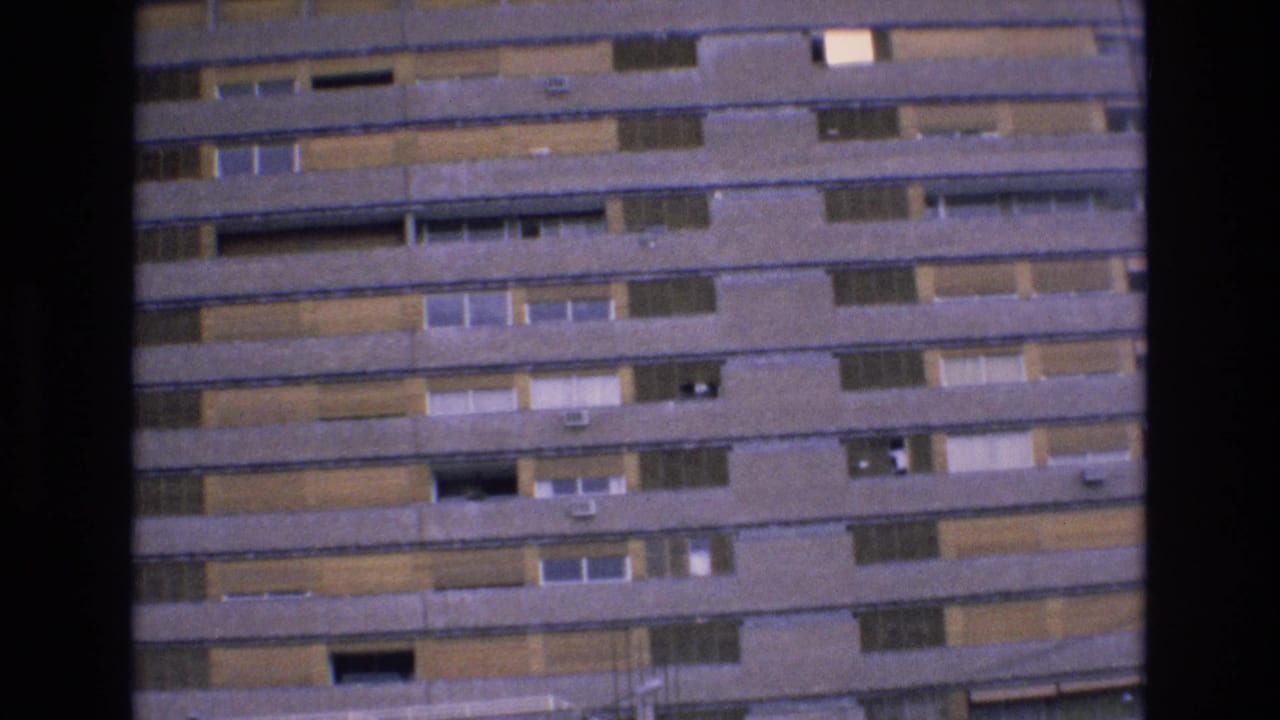1972 Spain 8mm frame showing a tall mid-century building facade with repeated balconies, windows, and dark film borders.