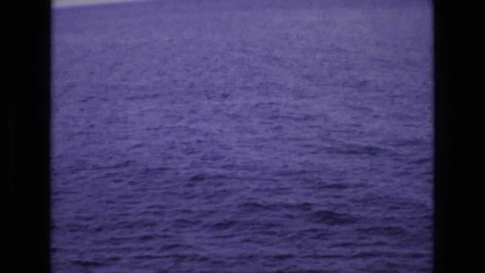 1972 Spain 8mm frame dominated by textured ocean surface, with a narrow pale band near the top and visible film border.