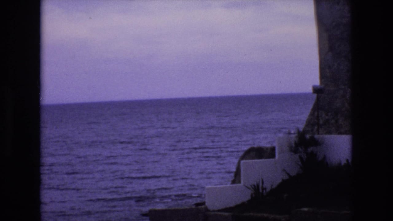 Open ocean view with white steps and a stone structure along the right edge.