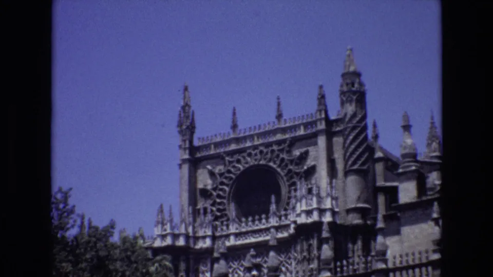 1972 Spain travel frame showing an ornate Gothic-style cathedral or historic building facade with spires and tracery against a blue sky.
