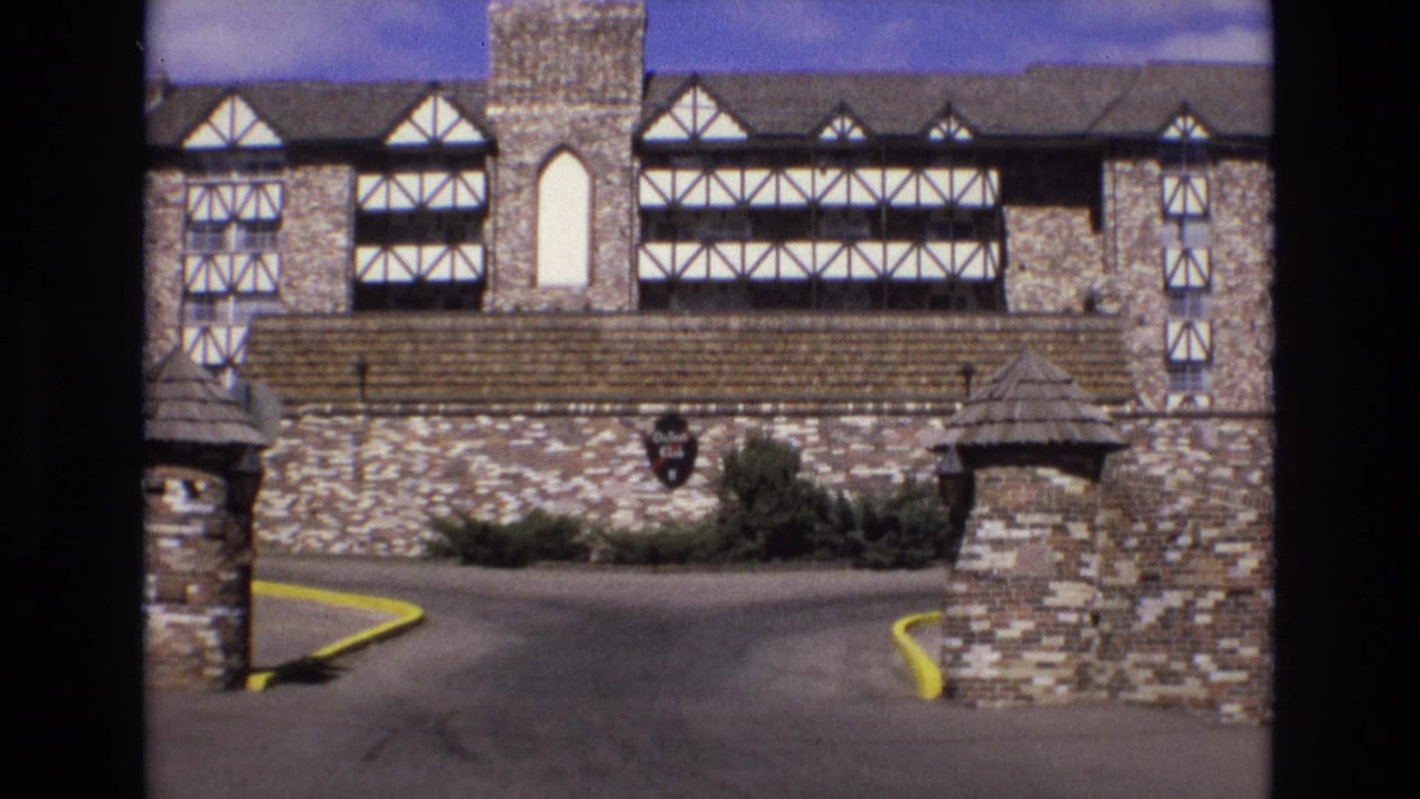 Stone and half-timbered building with driveway entrance and wall-mounted club sign.