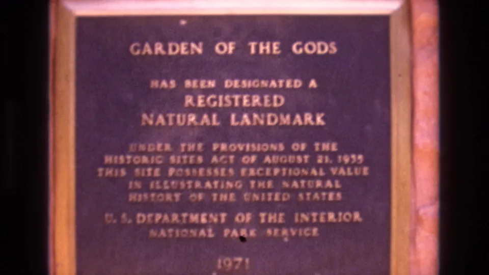 1973 Colorado 8mm frame holding on the Garden of the Gods plaque, with the National Park Service line and 1971 date visible near the lower area.