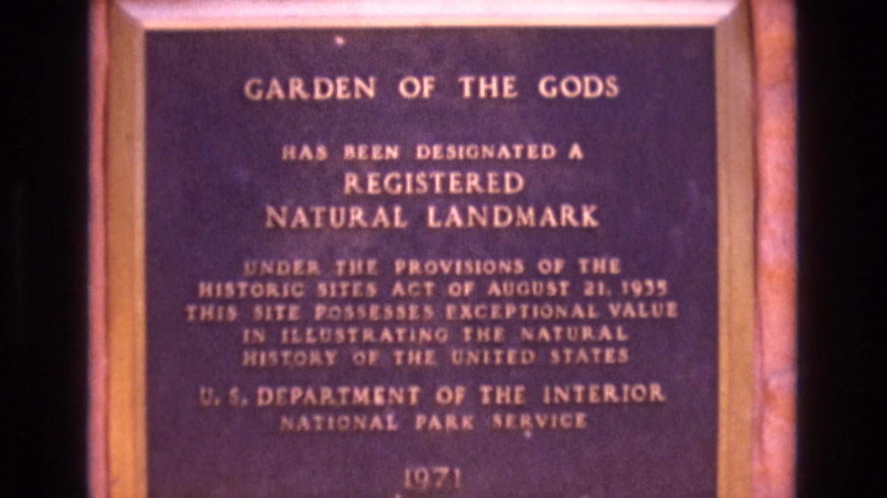 Brass Garden of the Gods Registered Natural Landmark plaque in a wooden frame.