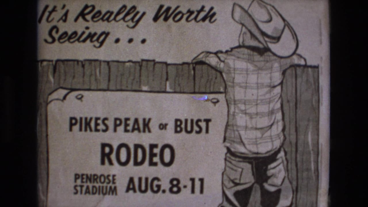 1973 Colorado Springs 8mm frame showing a hand-drawn Pikes Peak or Bust Rodeo poster for Penrose Stadium with a cowboy leaning on a fence.