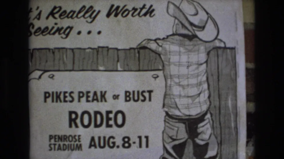 1973 Colorado Springs frame of a Pikes Peak or Bust Rodeo promotional poster, showing bold event lettering, Penrose Stadium text, and a cowboy leaning over a fence.
