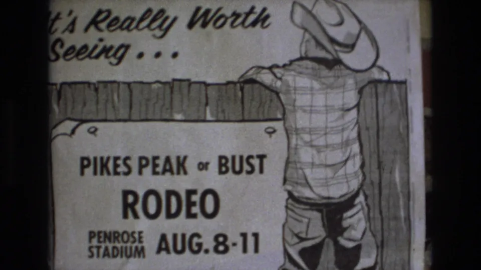 8mm home-movie frame showing the same Pikes Peak or Bust Rodeo poster with the cowboy illustration, fence line, Penrose Stadium wording, and August 8-11 dates visible.