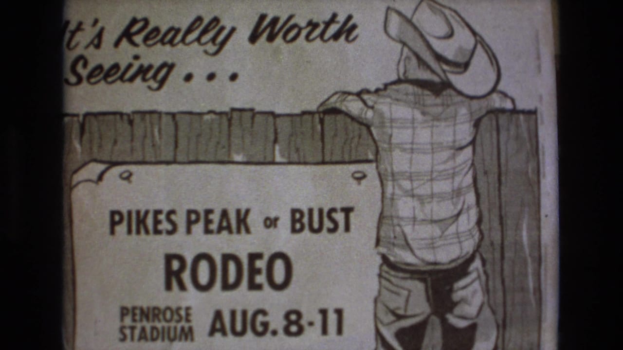 1973 Colorado Springs home-movie frame showing a hand-drawn Pikes Peak or Bust Rodeo poster with cowboy artwork, fence graphic, and Penrose Stadium August 8-11 text.