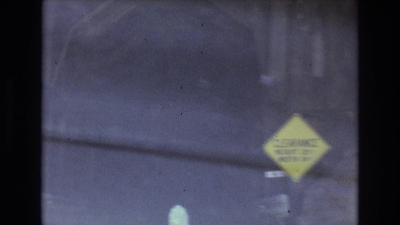 Dark tunnel interior with a yellow clearance sign near the right side of the frame.