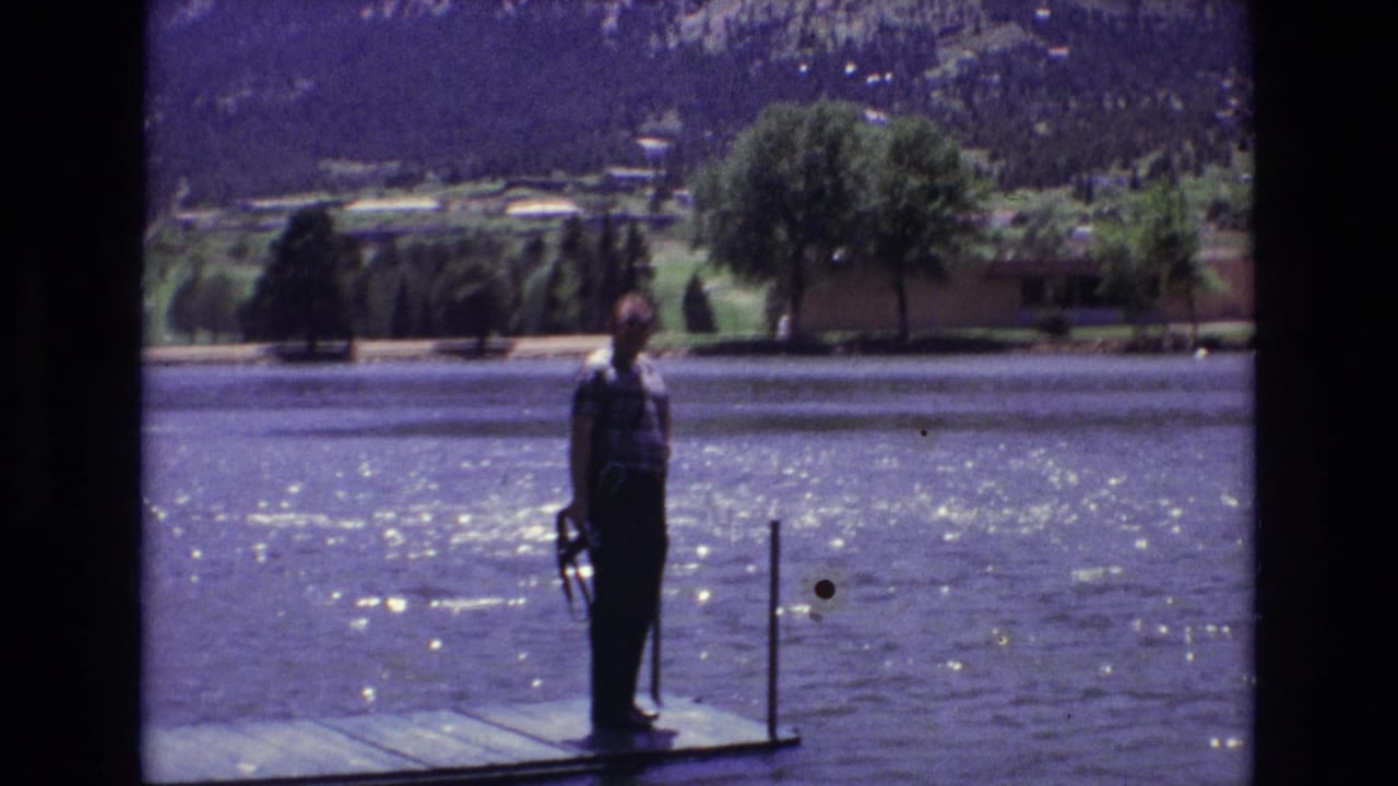 A man stands on a wooden dock holding a fishing rod beside a sunlit lake in Colorado Springs, Colorado, as supported by the clip metadata.