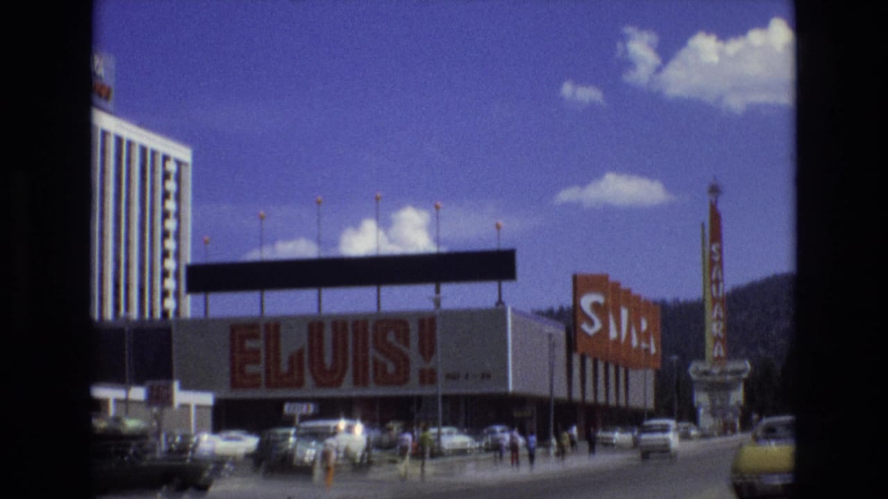 1973 Lake Tahoe, Nevada street-level view of the Sahara hotel with ELVIS! lettering across the facade, cars in front, pedestrians, and a vertical Sahara sign.
