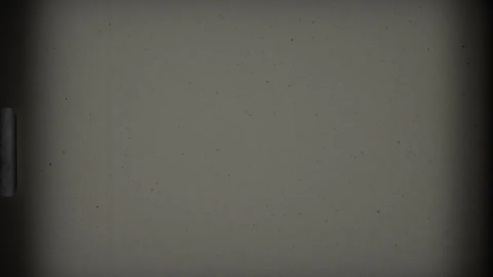 A dark blank 8mm frame shows the film gate, soft vignetting, dust specks, and a vertical strip consistent with leader or end-of-roll material.