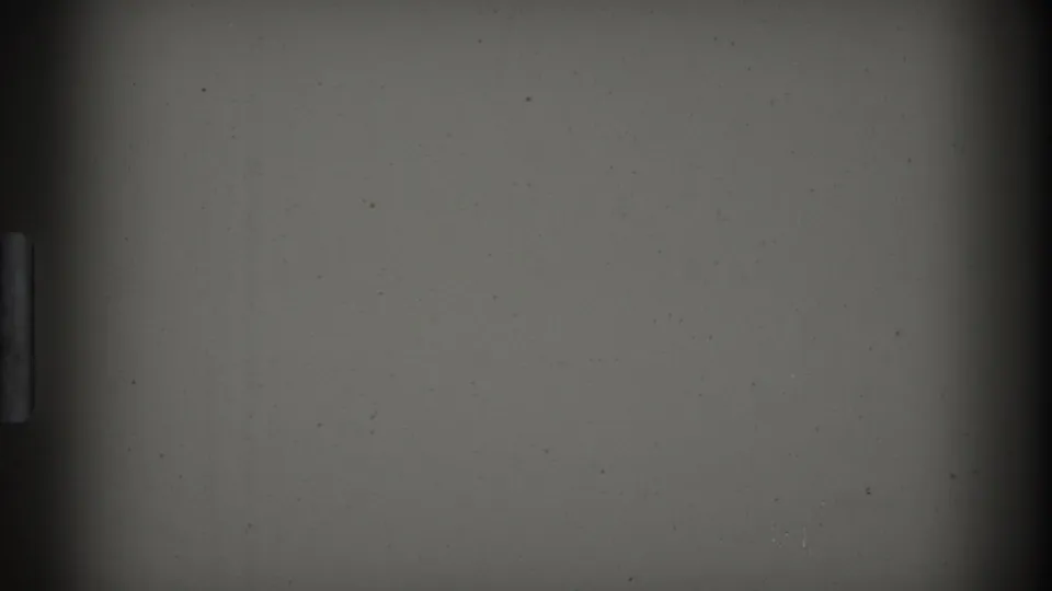 The final sampled frame is mostly blank gray 8mm leader with a dark vertical gate edge, scattered dust, and slight exposure variation.