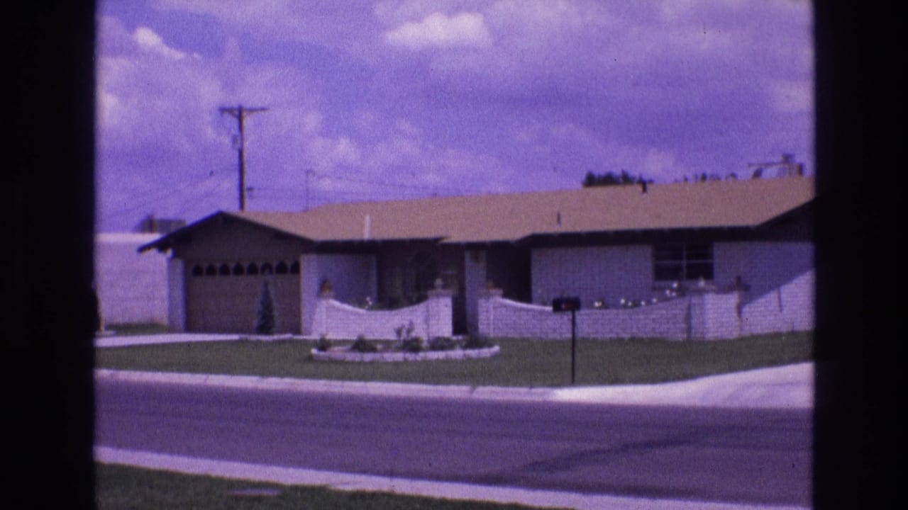 Suburban house with front yard, mailbox, and street viewed from a fixed camera position.