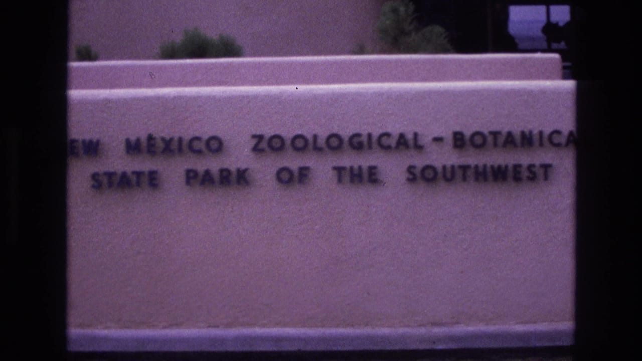 Engraved New Mexico Zoological-Botanical State Park sign on a pale wall.