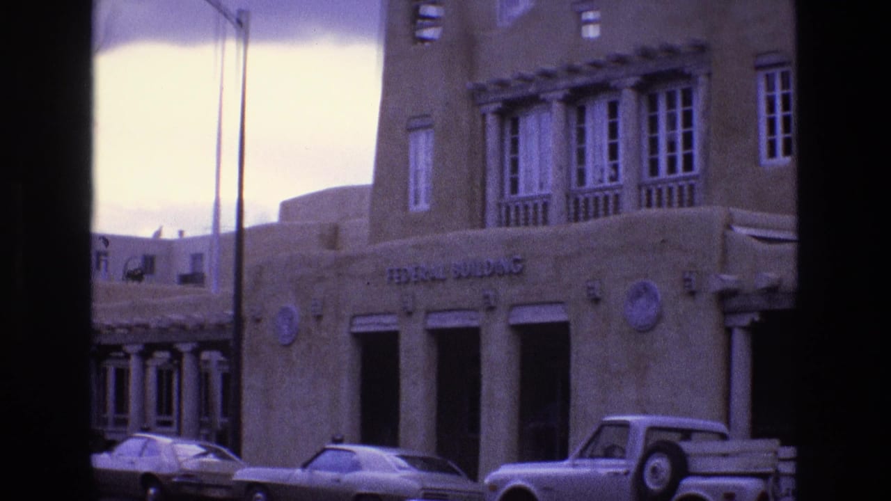 Federal Building exterior with columns, upper windows, and parked automobiles.