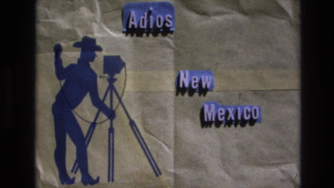 Second view of the "Adios New Mexico" title card with the blue cowboy photographer graphic.